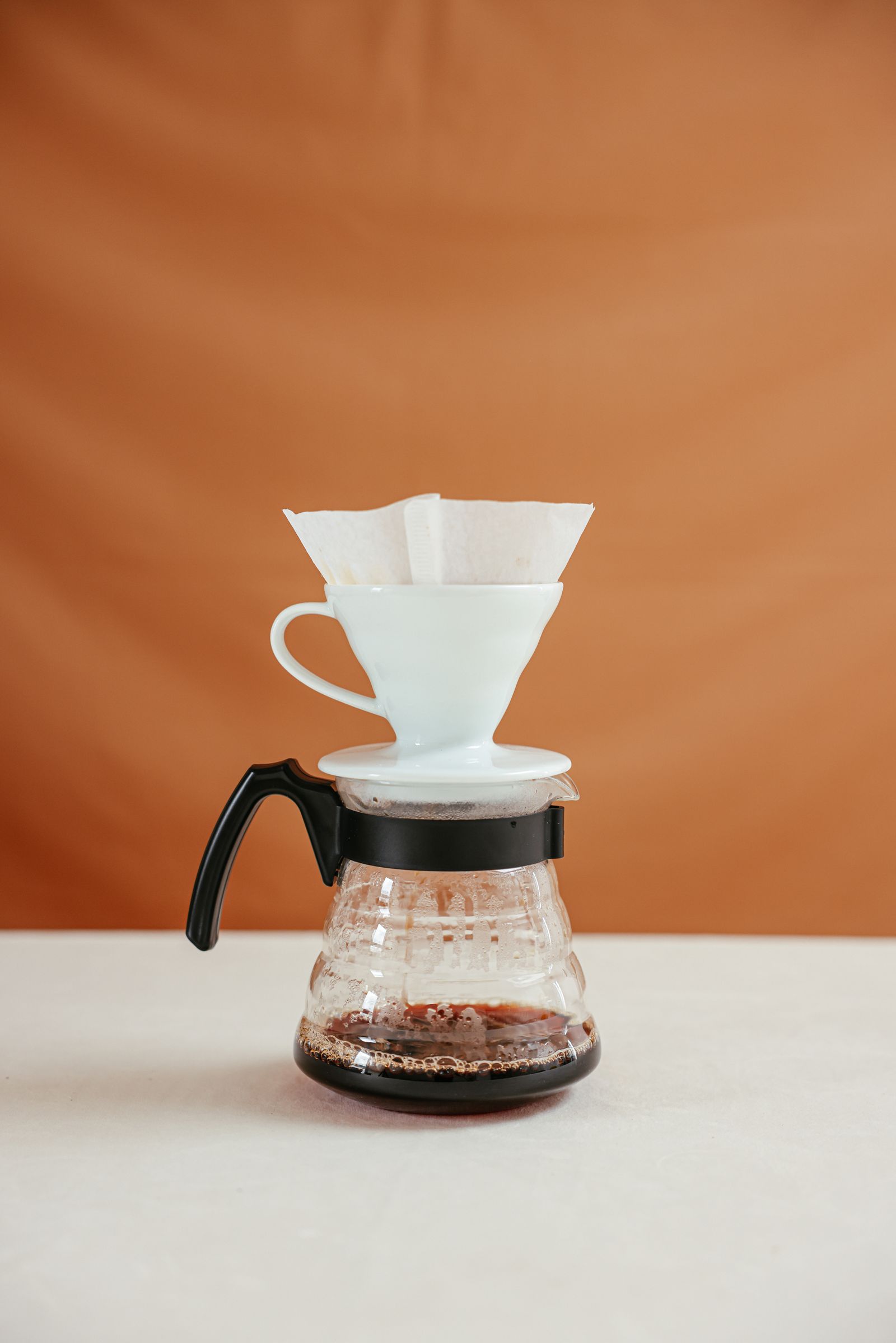 Clean white ceramic pour-over coffee setup